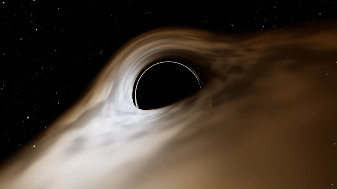 Gargantua, a spinning black hole, with its accretion disk bent over and under its shadow